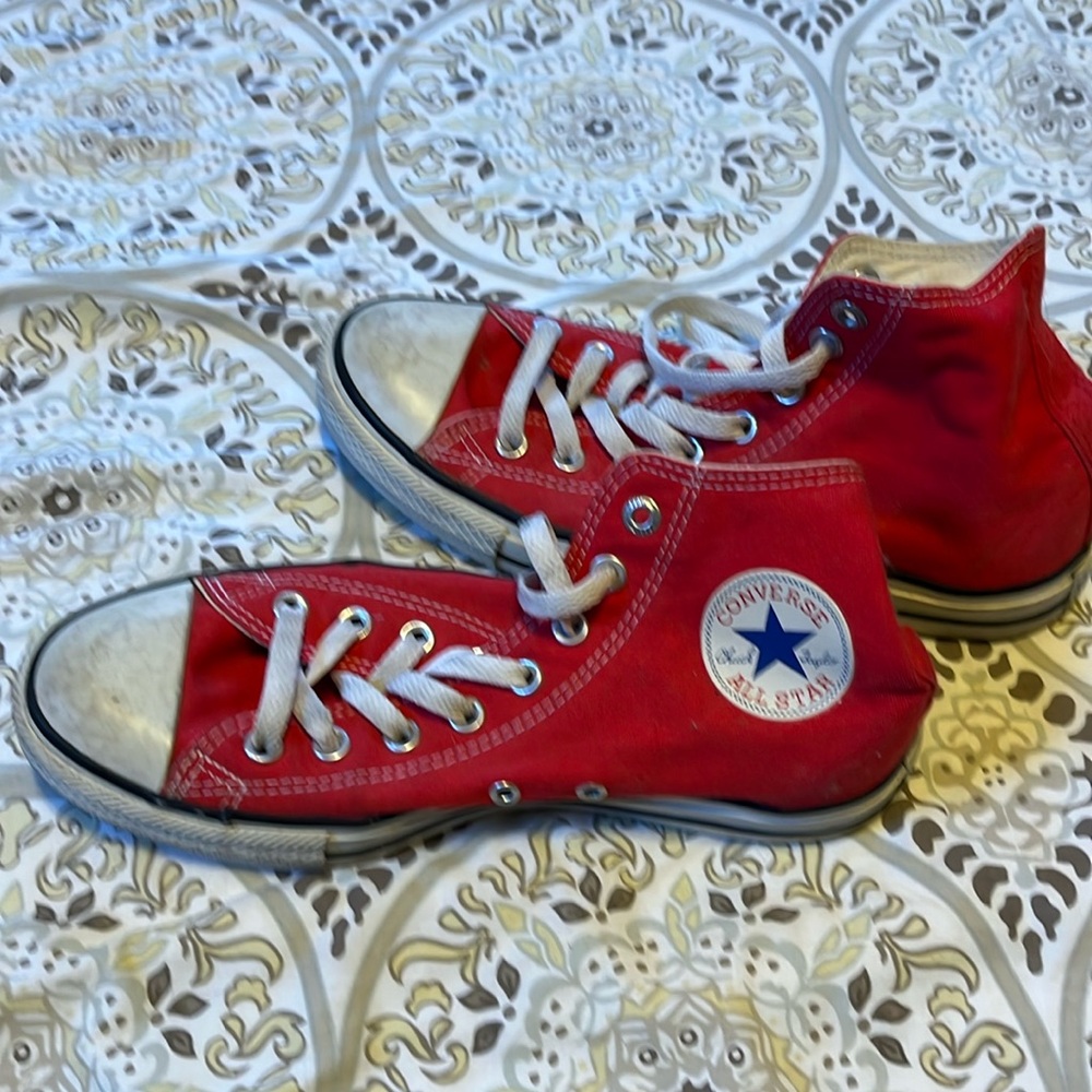 High top red canvas Converse. 
Men 7, and fit a woman size 9 shoe.